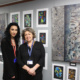 Lina Ogaily and ACS Hillingdon instructor standing in front of Lina's artwork